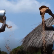 Mary and Stephen winnow maize for sale together
